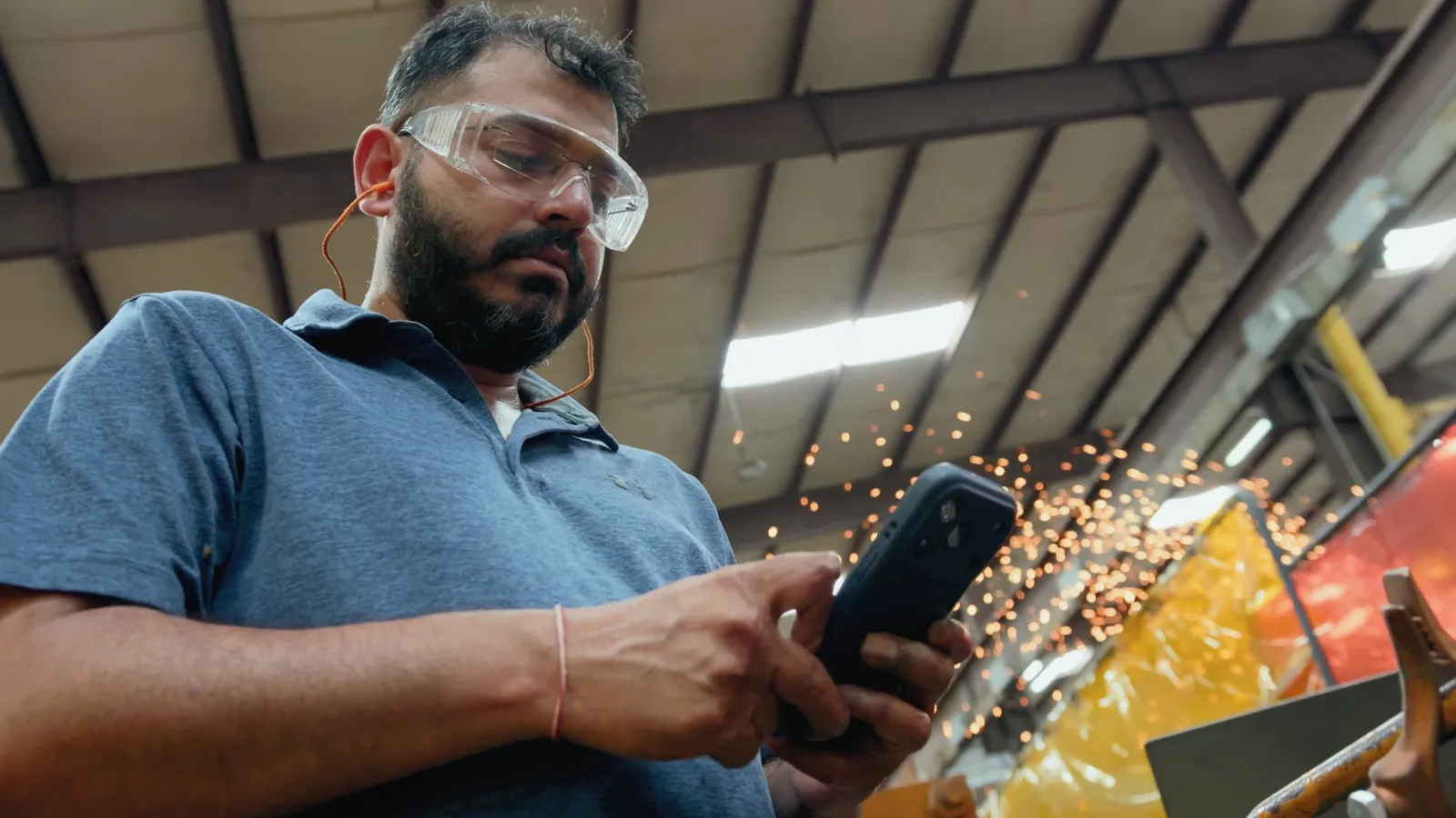 A Piping Technology & Products team member texting a Tasklet agent from the shop floor